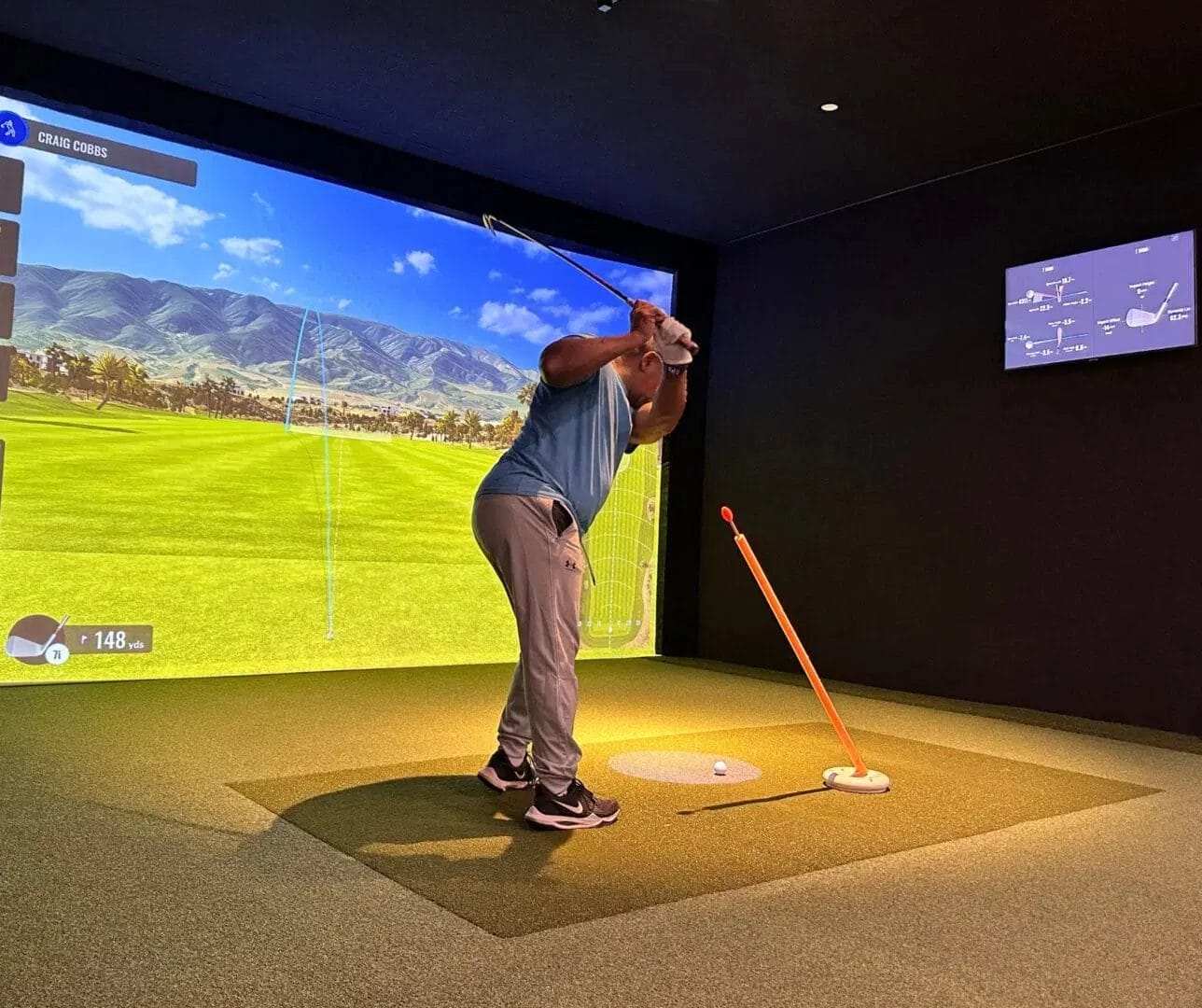 Art of Flight Golf Man setting up for a Shot on Golf Simulator